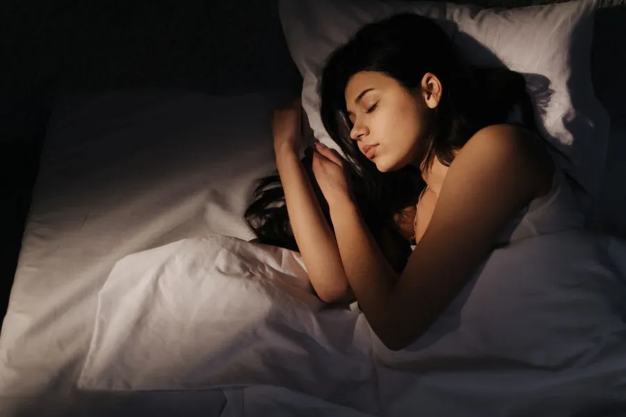 A woman sleeping soundly in her bed.